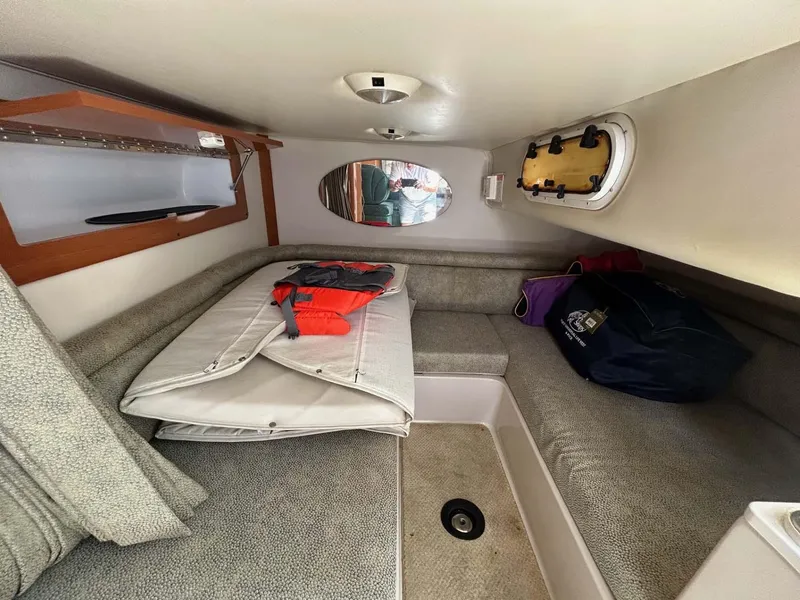 Slide: The Image of 2001 Four Winns 328 Vista cabin interior with cushions and storage. - 15