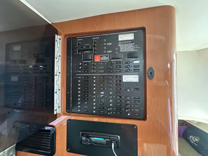 Slide: The Image of Control panel of a 2001 Four Winns 328 Vista boat, featuring various switches and controls. - 17