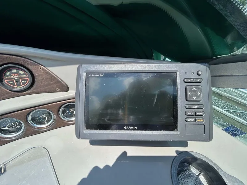 Slide: The Image of Garmin GPS device on 2001 Four Winns 328 Vista boat dashboard with gauges. - 18