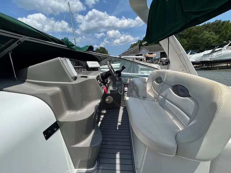 Slide: The Image of 2001 Four Winns 328 Vista boat interior with helm and seating under a blue sky. - 21