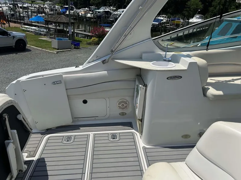 Slide: The Image of 2001 Four Winns 328 Vista boat deck with seating and storage, docked at marina. - 24