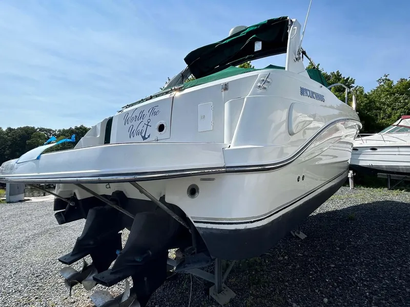 Slide: The Image of 2001 Four Winns 328 Vista boat on gravel, rear view, sunny day. - 33