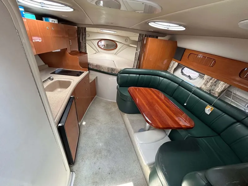 Slide: The Image of Interior of 2001 Four Winns 328 Vista boat with kitchenette and seating area. - 6