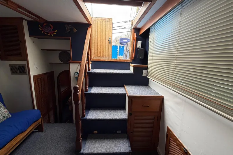 Slide: The Image of Interior of 1984 Golden Star 38 Trawler with stairs, wooden accents, and window blinds. - 48