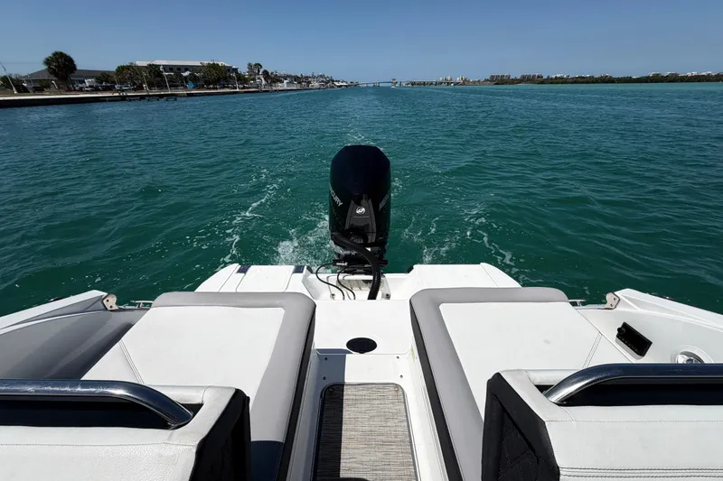 Slide: The Image of 2022 Cobalt R6 Outboard cruising on clear blue water, rear view of boat deck. - 10