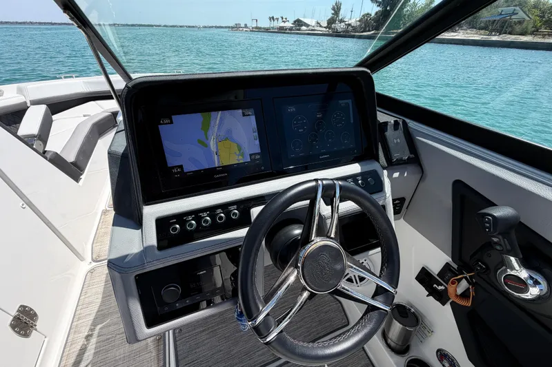 Slide: The Image of 2022 Cobalt R6 Outboard boat dashboard with navigation display and steering wheel. - 13
