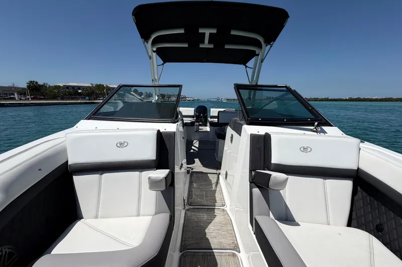 Slide: The Image of 2022 Cobalt R6 Outboard boat interior with white seating, on a sunny day at sea. - 14
