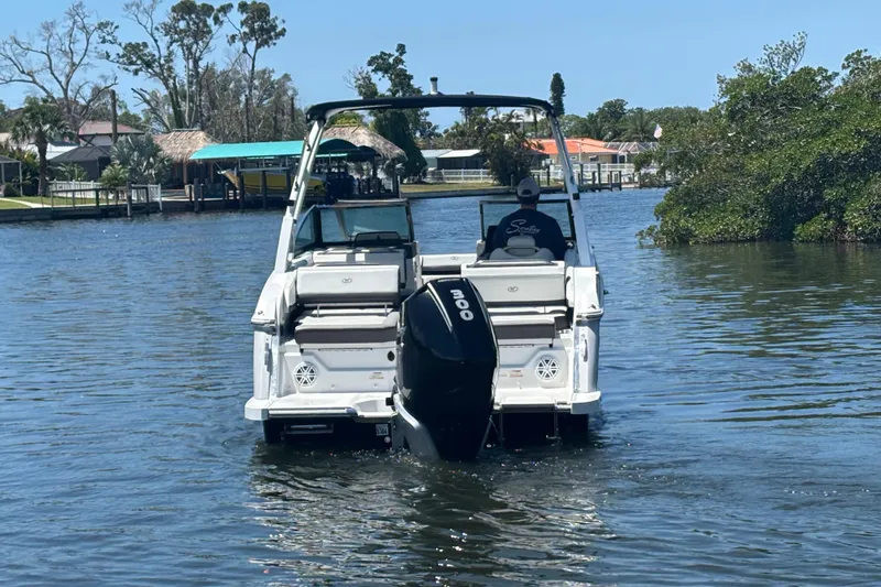 Slide: The Image of 2022 Cobalt R6 Outboard boat cruising on a calm waterway. - 6