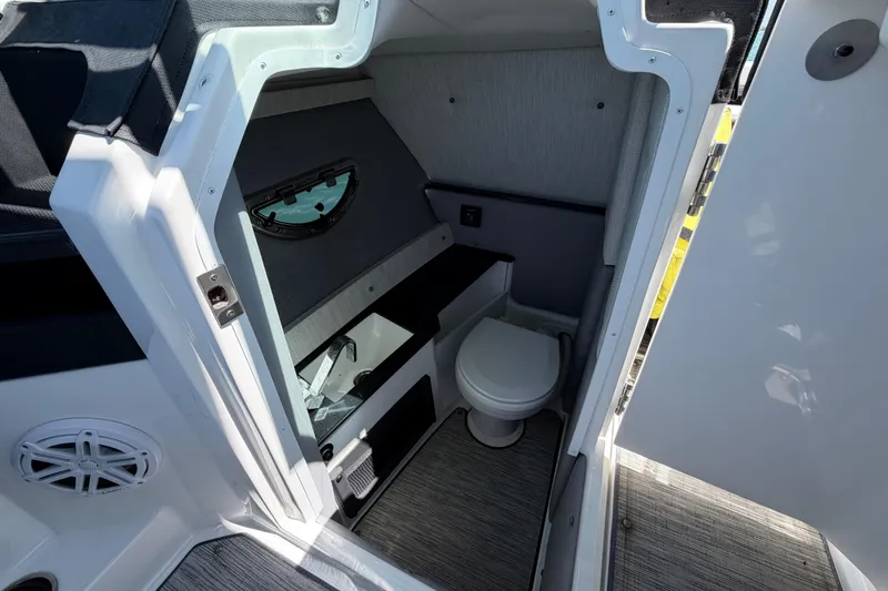 Slide: The Image of 2022 Cobalt R6 Outboard boat interior with compact bathroom and toilet. - 8