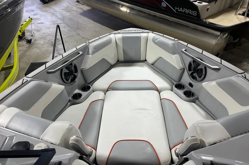 Slide: The Image of 2021 Malibu Wakesetter 25 LSV boat interior with cushioned seating and cup holders. - 9