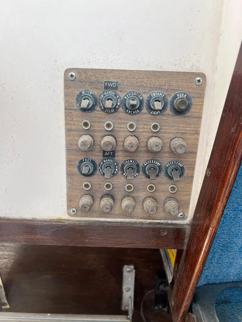 Slide: The Image of Control panel of a 1987 Grady-White Seafarer 226 boat with various switches and dials. - 10