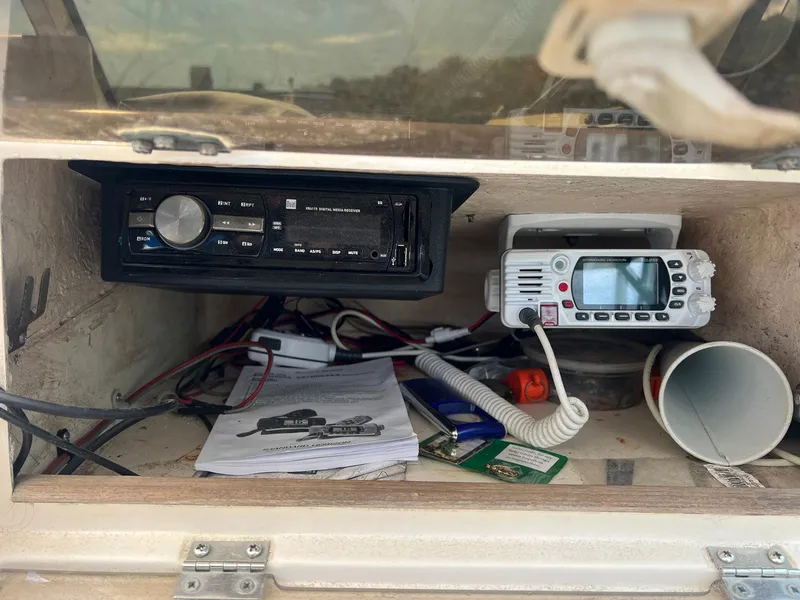 Slide: The Image of 1987 Grady-White Seafarer 226 dashboard with radio and communication equipment. - 12
