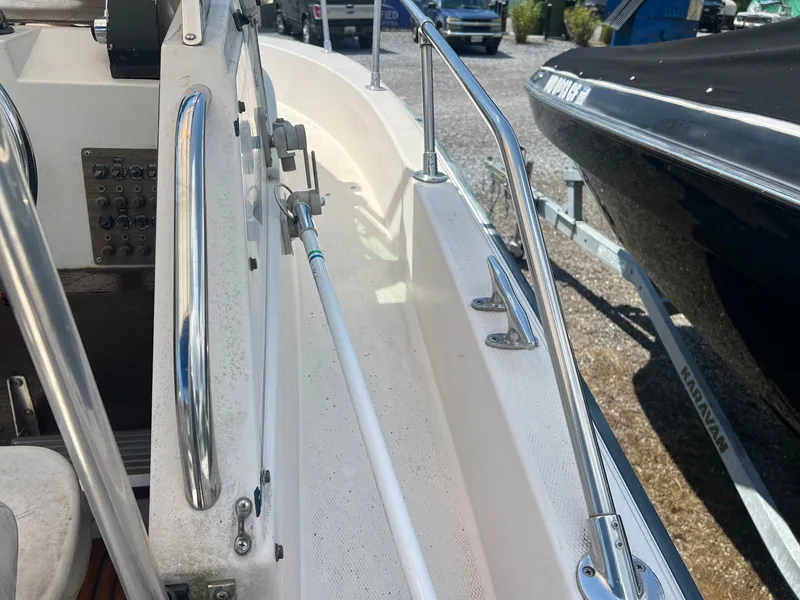 Slide: The Image of 1987 Grady-White Seafarer 226 boat interior with stainless steel railings and control panel. - 15