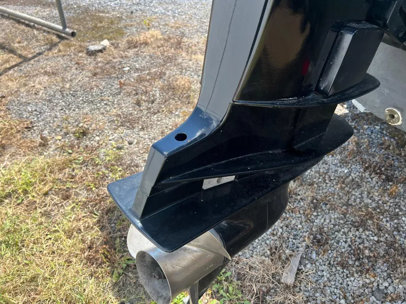 Slide: The Image of Outboard motor detail of 1987 Grady-White Seafarer 226 on gravel and grass. - 20