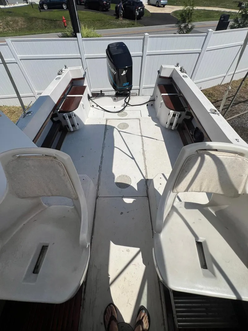 Slide: The Image of 1987 Grady-White Seafarer 226 boat interior with seating and outboard motor. - 7