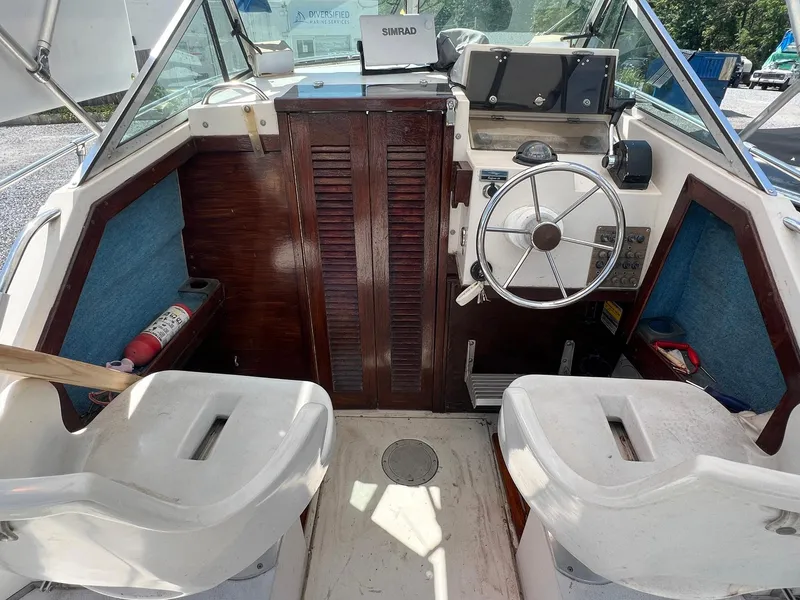 Slide: The Image of 1987 Grady-White Seafarer 226 boat interior with steering wheel and seating. - 8