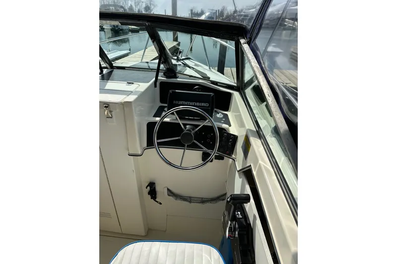 Slide: The Image of 2002 Arima Sea Ranger 21 Hardtop boat helm with steering wheel and Humminbird display. - 15