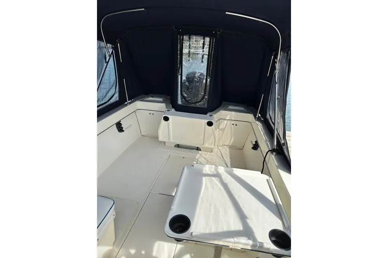 Slide: The Image of Interior view of 2002 Arima Sea Ranger 21 Hardtop boat with seating and canopy. - 17