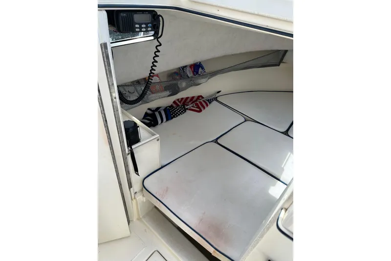 Slide: The Image of Interior cabin of 2002 Arima Sea Ranger 21 Hardtop with radio and American flag decor. - 4