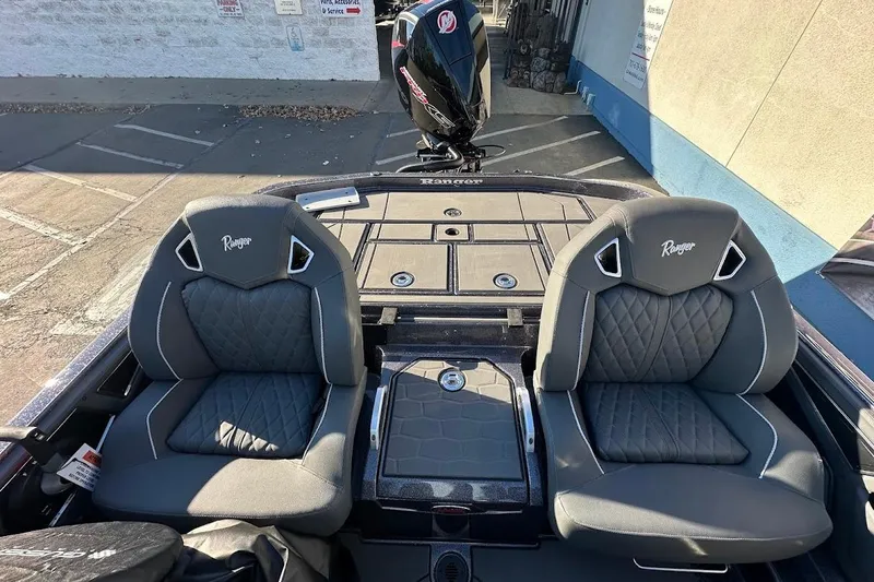 Slide: The Image of 2026 Ranger Z521R Garmin Cup-Equipped boat interior with dual gray seats and storage compartments. - 17
