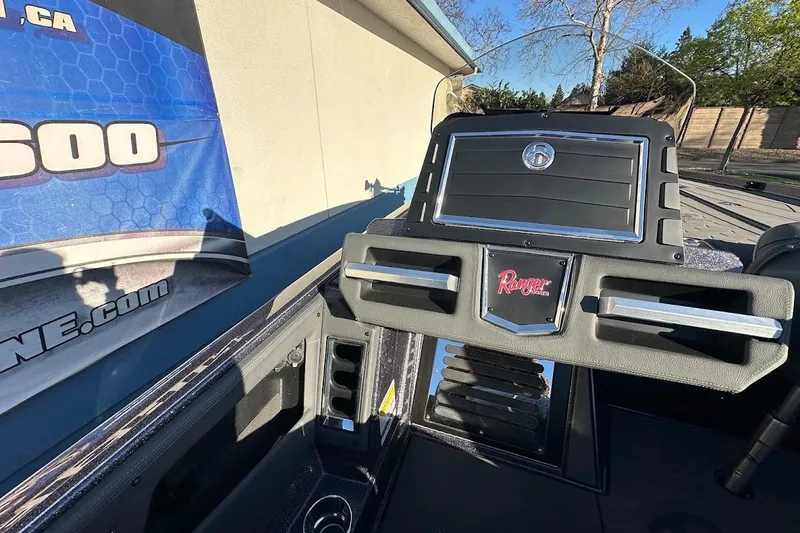 Slide: The Image of 2026 Ranger Z521R Garmin Cup-Equipped boat console with branding and sleek design. - 18