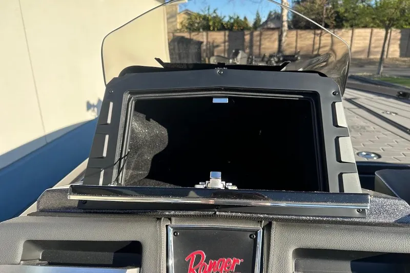 Slide: The Image of 2026 Ranger Z521R Garmin Cup-Equipped boat dashboard with windshield and control panel. - 19