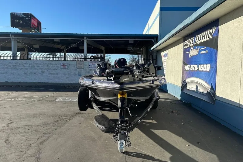 Slide: The Image of 2026 Ranger Z521R Garmin Cup-Equipped boat parked outside a fishing store. - 2