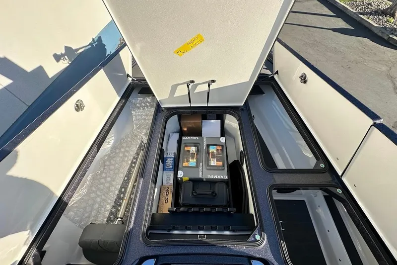Slide: The Image of 2026 Ranger Z521R boat storage compartment with Garmin equipment and accessories. - 26