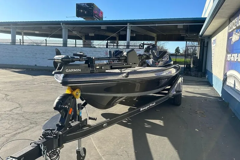 Slide: The Image of 2026 Ranger Z521R boat equipped with Garmin technology, parked outdoors on a sunny day. - 3