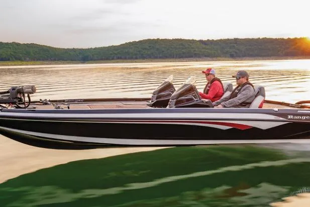 Slide: The Image of 2026 Ranger Z521R Garmin Cup-Equipped boat cruising on a serene lake at sunset. - 35