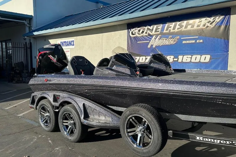 Slide: The Image of 2026 Ranger Z521R Garmin Cup-Equipped boat parked outside a marine shop. - 5
