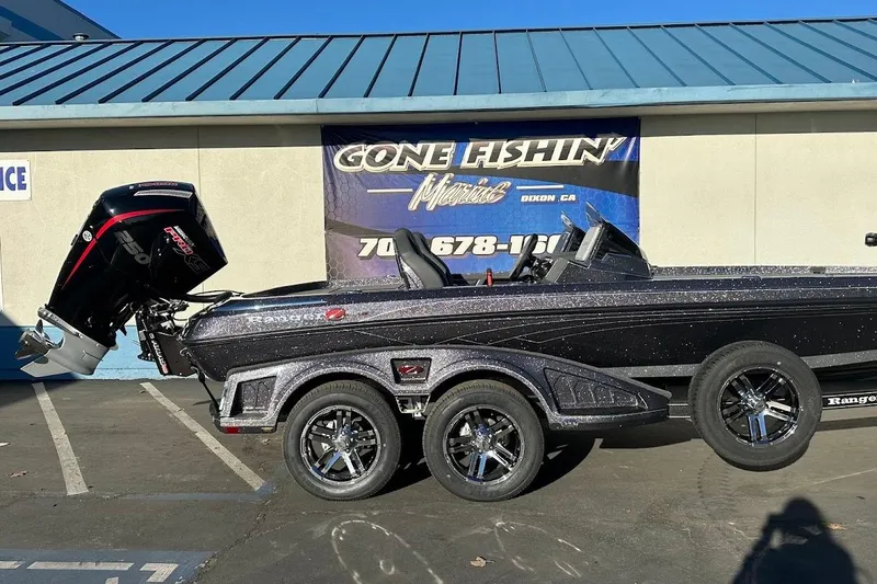 Slide: The Image of 2026 Ranger Z521R Garmin Cup-Equipped boat with powerful outboard motor, parked outside dealership. - 6