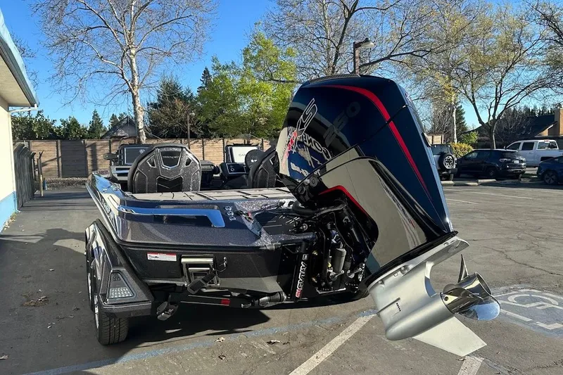 Slide: The Image of 2026 Ranger Z521R Garmin Cup-Equipped boat with powerful outboard motor in parking lot. - 9