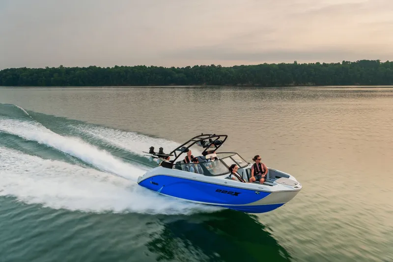 The Image of 2026 Yamaha Boats 222XD cruising on a serene lake at sunset. - 0