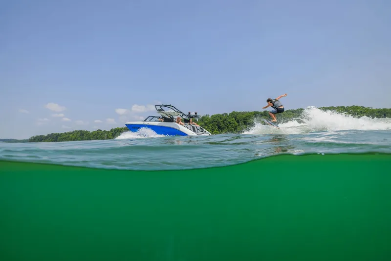 Slide: The Image of Yamaha 222XD 2026 towing wakeboarder on lake. - 24