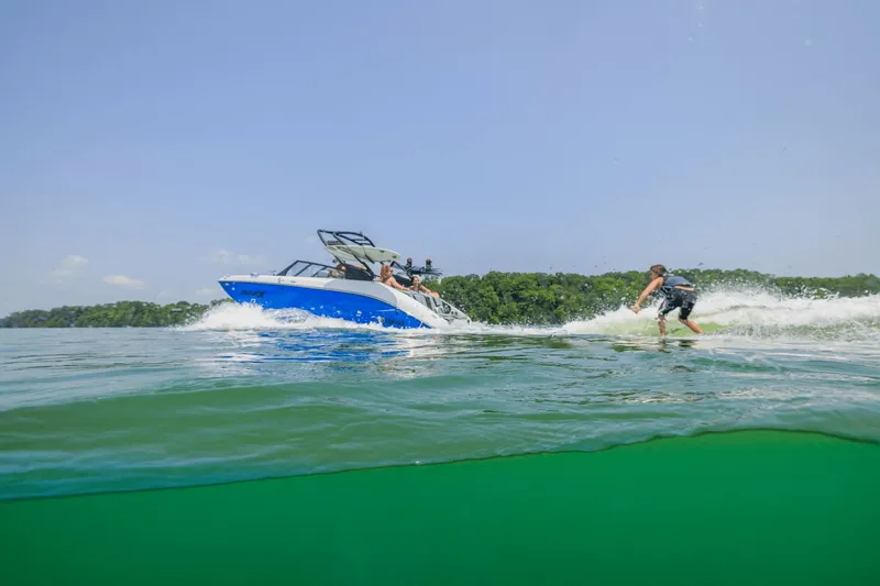 Slide: The Image of Yamaha Boats 222XD 2026 towing wakeboarder on lake. - 25