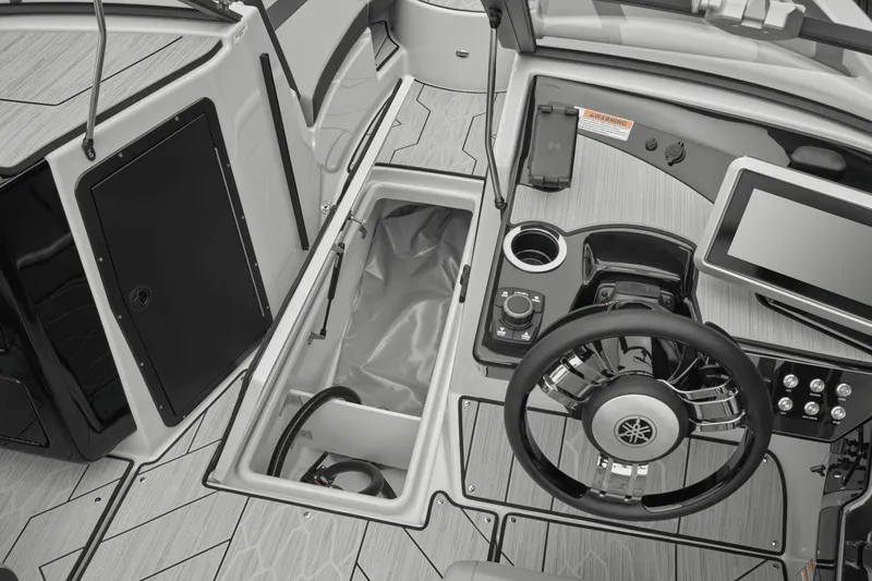 Slide: The Image of Interior view of 2026 Yamaha Boats 222XD cockpit with controls and storage. - 5