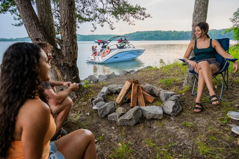 Slide: The Image of Yamaha AR220 boat by the lake with friends at a campfire, 2026 model. - 6