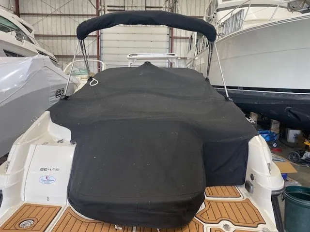 Slide: The Image of 2012 Monterey 264FS boat with cover in storage facility. - 1