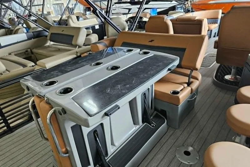 Slide: The Image of Luxurious 2026 Starcraft SLS 3 DL DH BAR pontoon boat interior with seating and table. - 8