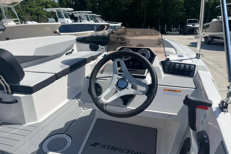 Slide: The Image of 2026 Starcraft SV 16 OB boat interior with steering wheel and seating. - 12
