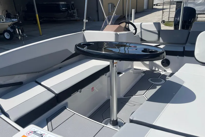 Slide: The Image of 2026 Starcraft SV 16 OB boat interior with seating and a central table. - 17