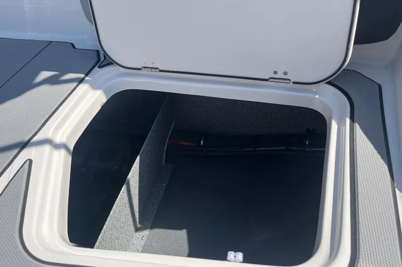 Slide: The Image of Open storage compartment on 2026 Starcraft SV 16 OB boat, showcasing interior space. - 26