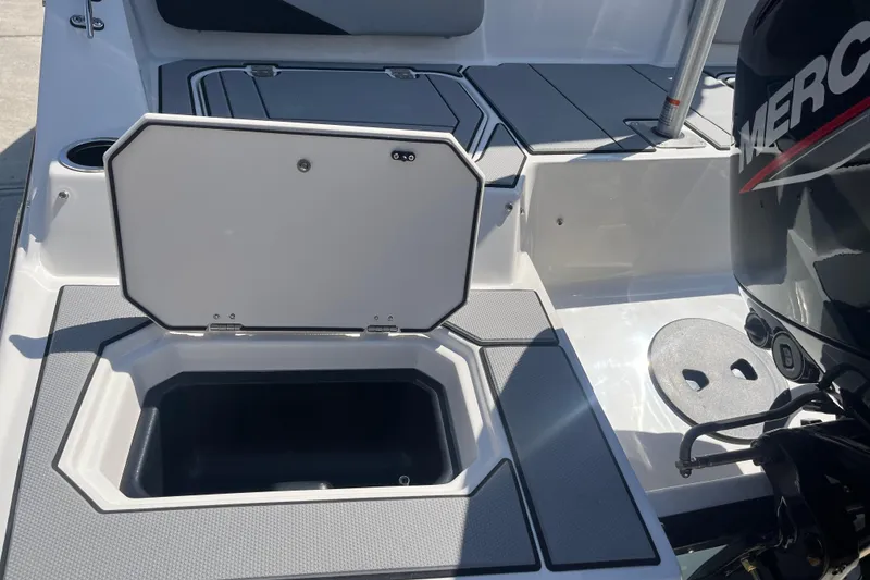 Slide: The Image of 2026 Starcraft SV 16 OB boat with open storage compartment and Mercury outboard motor. - 28