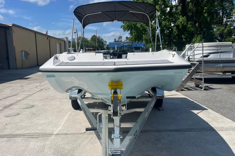 Slide: The Image of 2026 Starcraft SV 16 OB boat on trailer, parked outdoors under blue sky. - 3