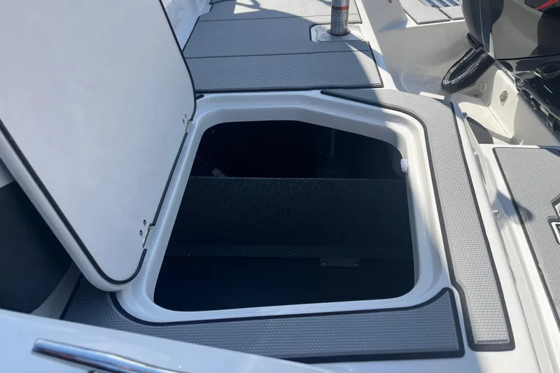 Slide: The Image of Open storage compartment on 2026 Starcraft SV 16 OB boat deck. - 31