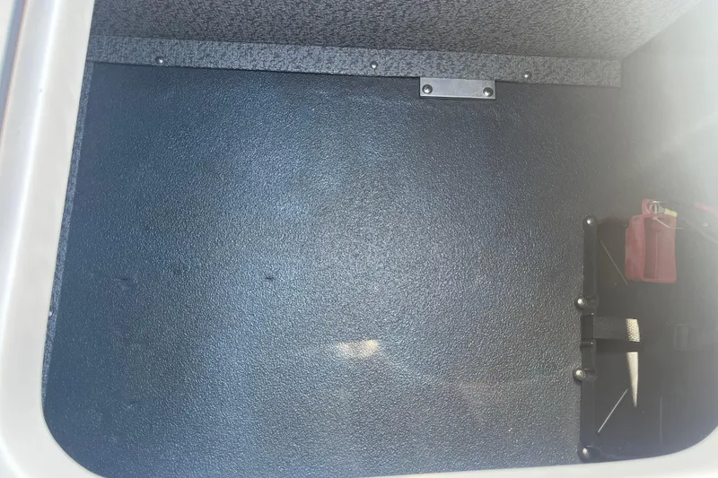 Slide: The Image of Storage compartment of 2026 Starcraft SV 16 OB boat, featuring textured interior. - 33