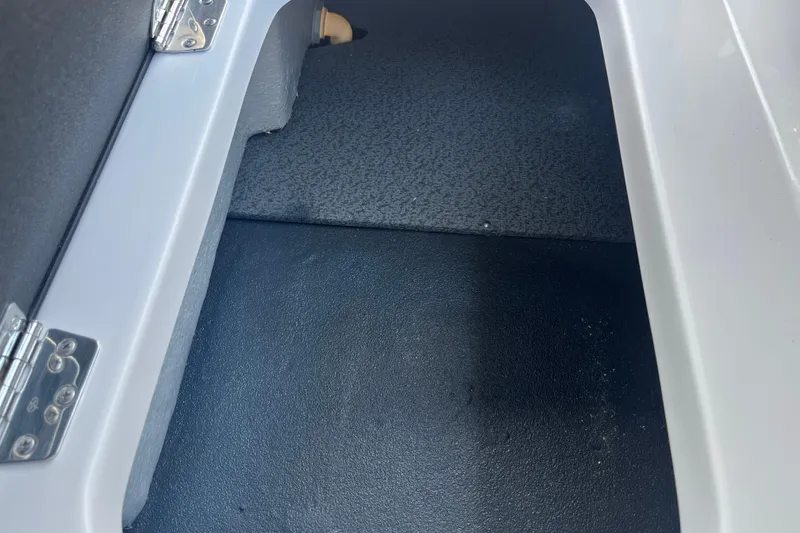Slide: The Image of Interior view of 2026 Starcraft SV 16 OB boat compartment with metal hinges. - 36