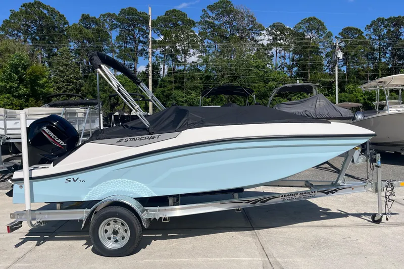 Slide: The Image of 2026 Starcraft SV 16 OB boat on trailer, covered, with Mercury outboard motor. - 38