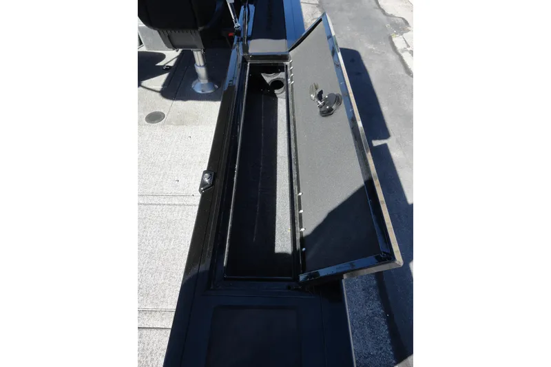 Slide: The Image of 2022 Tracker Targa V-19 Combo boat storage compartment open, showcasing interior space. - 16